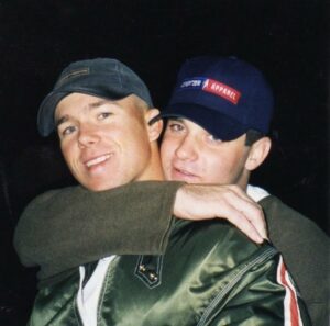 A younger Matt Miller posing for a photo with another man who has put his arm around Matt's neck