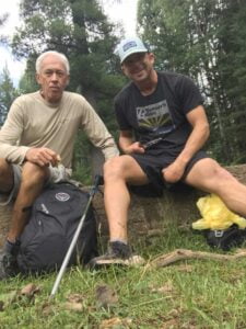 Matt Miller, motivational coach, outdoors in nature sitting with close friend