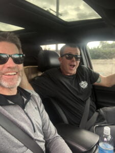 Matt Miller inside a car with a friend