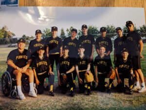 Photo of a baseball team of teenagers wearing shirts that say 'PIRATES'